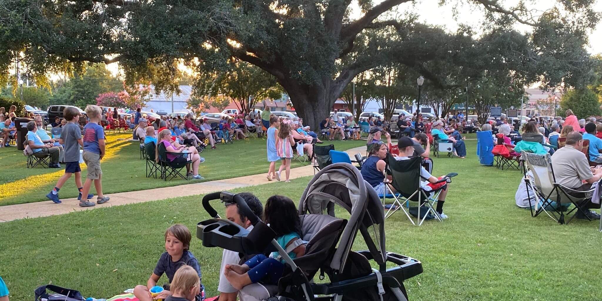 Under the Oaks event with crowds in a park